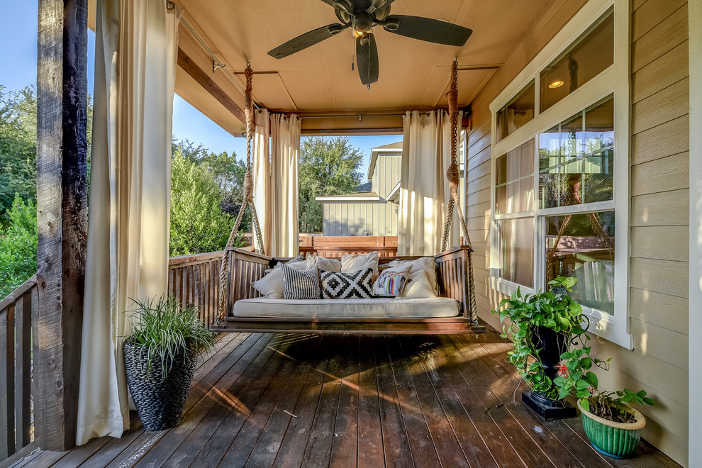 Inspiration for a traditional front veranda in Austin with a potted garden, a roof extension and decking.
