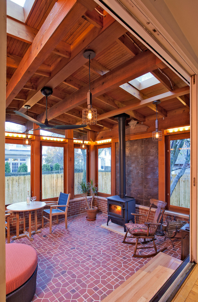 Inspiration for a traditional back veranda in DC Metro with brick paving and a roof extension.