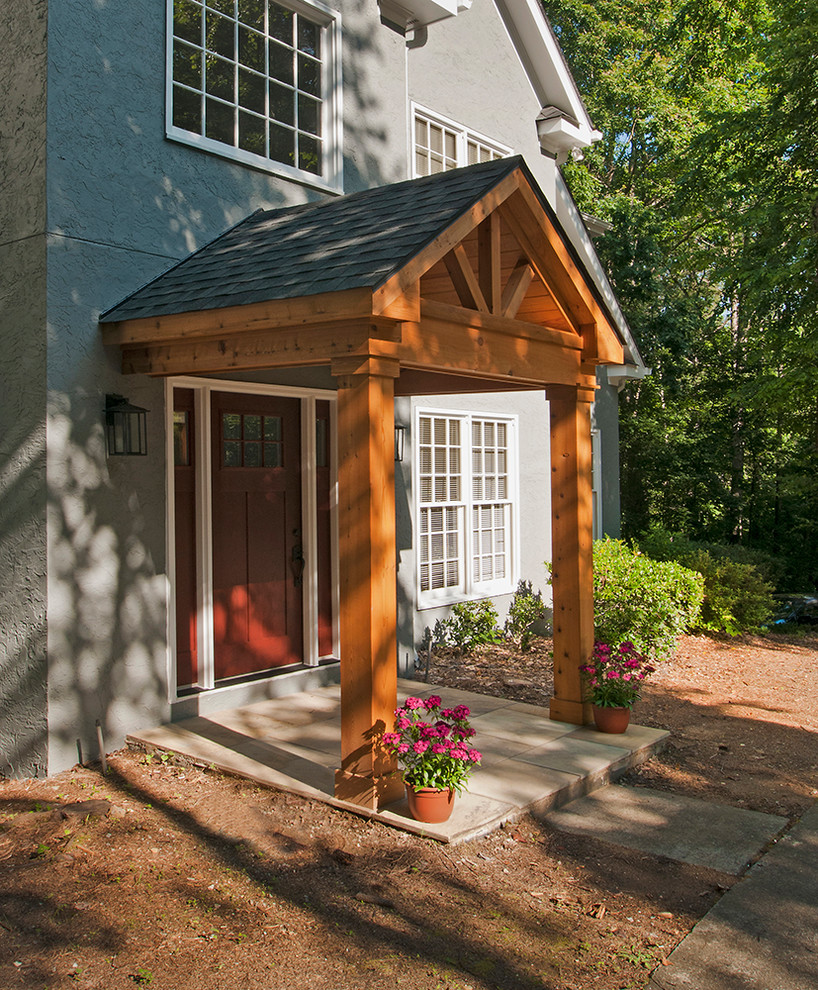 Inspiration for a transitional front porch remodel in Atlanta with a roof extension