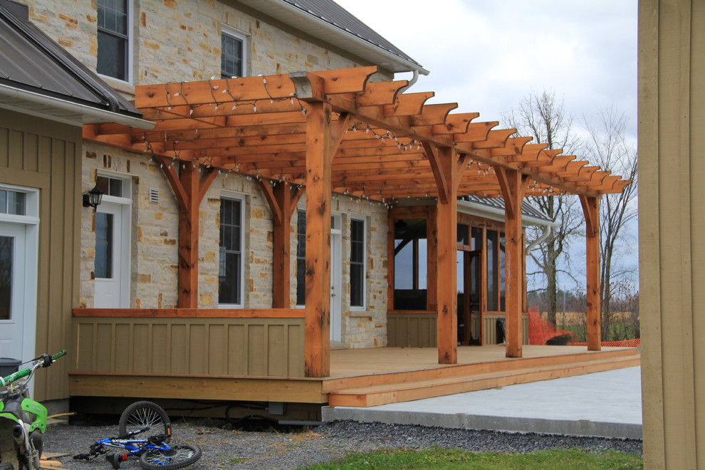 This is an example of a traditional porch design in Montreal with decking and a pergola.