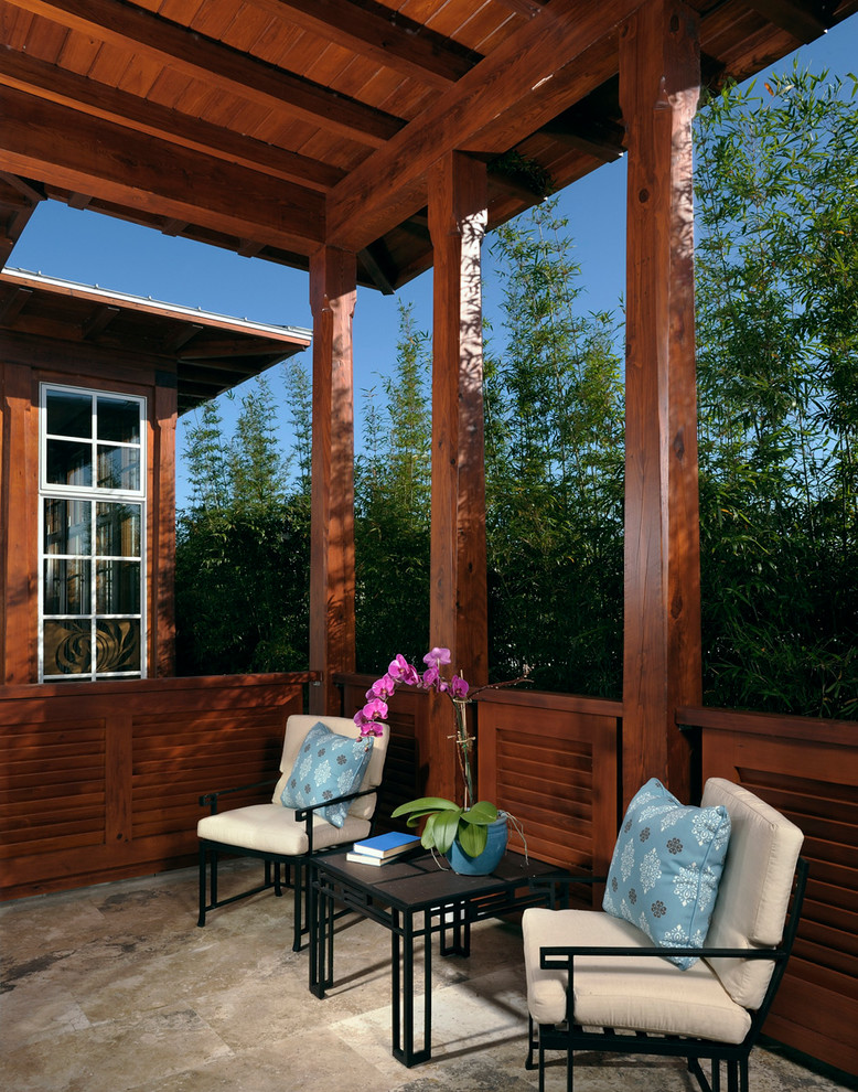 Photo of a world-inspired veranda in Orlando with a roof extension.