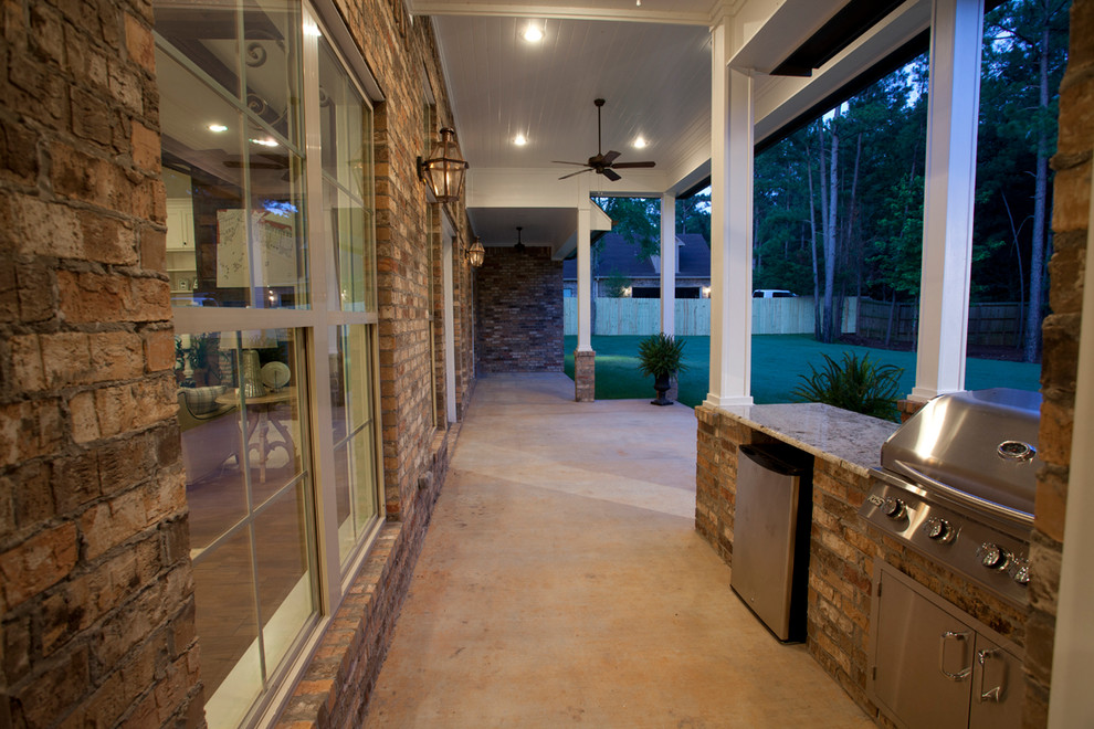 На фото: большая веранда на заднем дворе в стиле кантри с летней кухней, покрытием из бетонных плит и навесом с