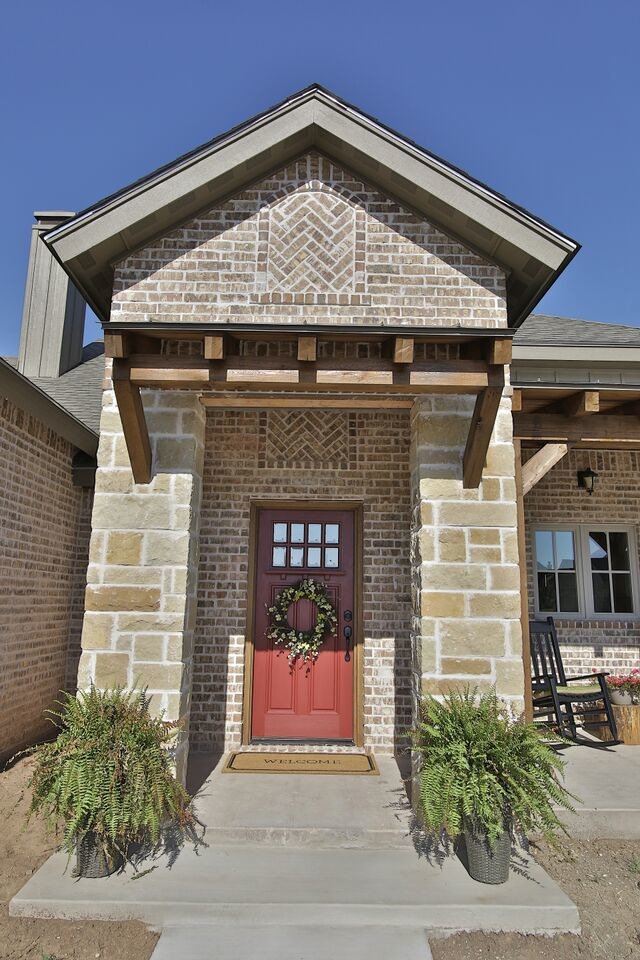 This is an example of a small traditional concrete paver porch design in Austin with a roof extension.