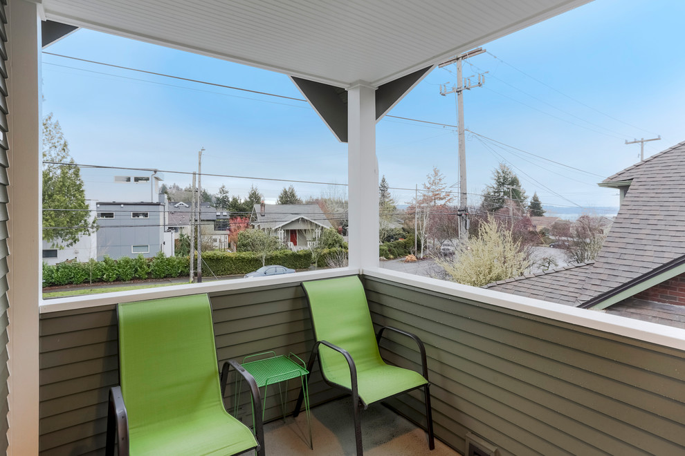 This is an example of a small traditional side veranda in Seattle with a roof extension.