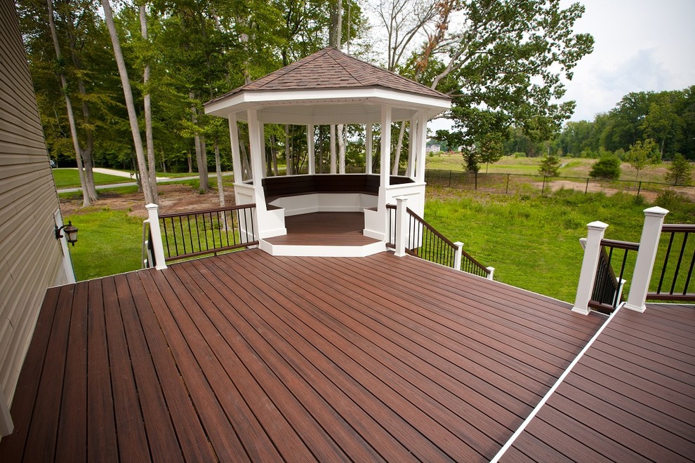This is an example of a large classic back veranda in Philadelphia with decking and a roof extension.