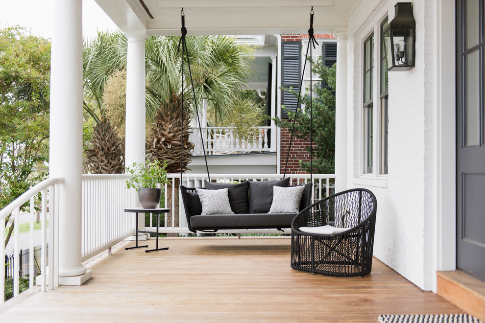 Transitional front porch idea in Charleston with decking and a roof extension