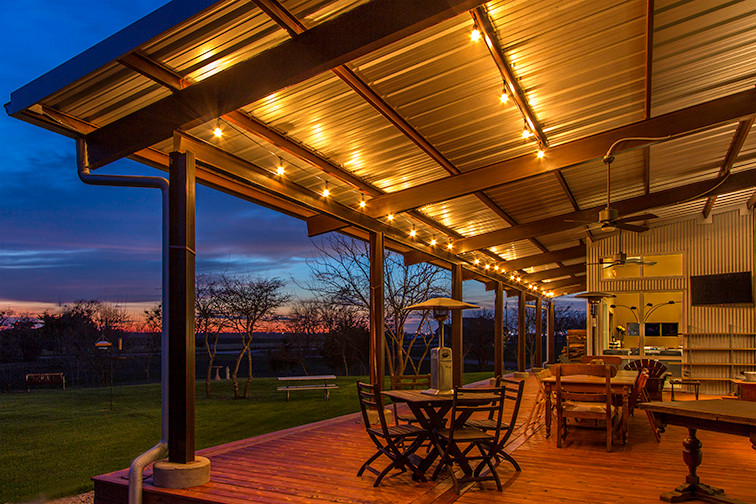 Large trendy back porch photo in Austin with a roof extension