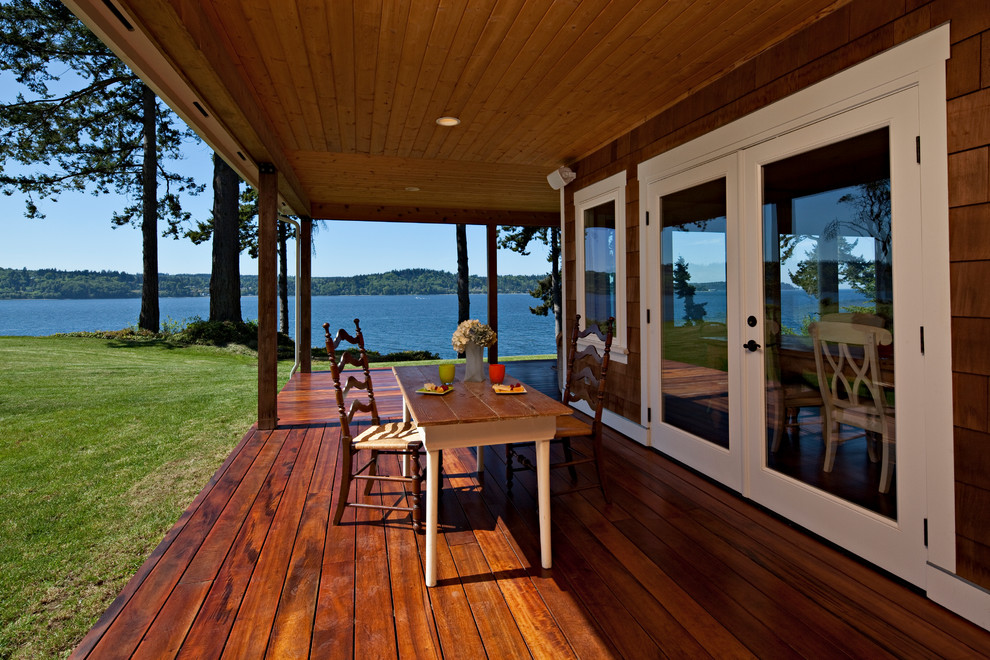 Inspiration for a timeless porch remodel in Seattle with decking and a roof extension