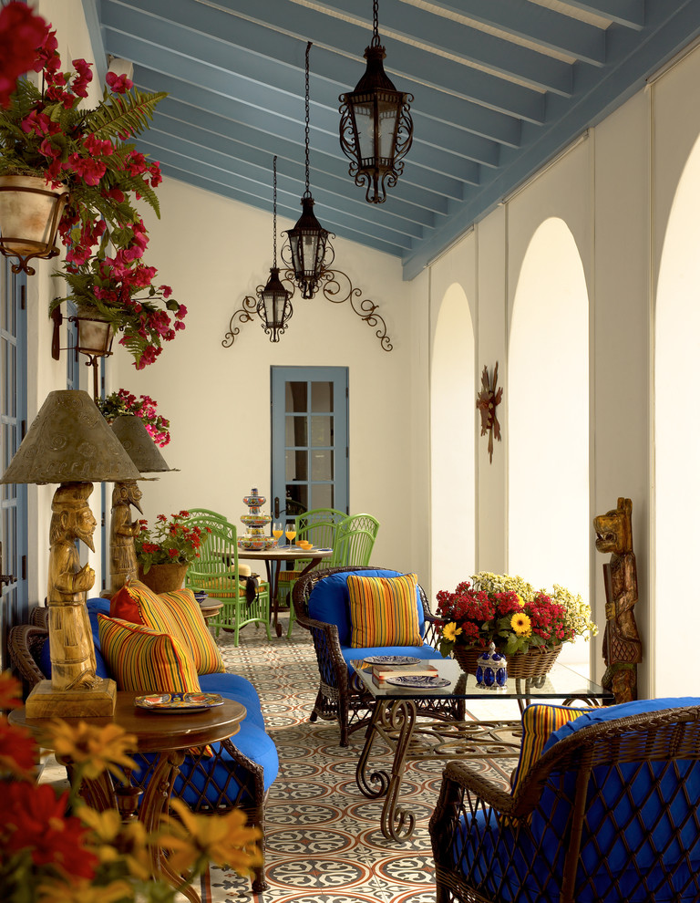 Large tuscan tile porch photo in Miami with a roof extension