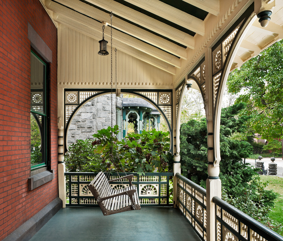 Ornate porch photo in Philadelphia with a roof extension