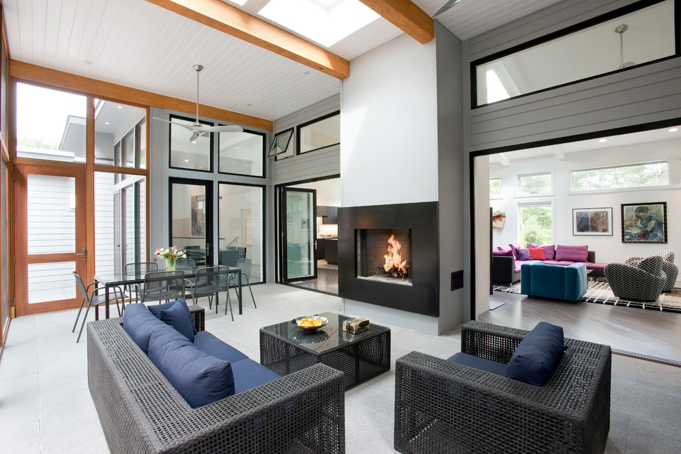 Inspiration for a large contemporary tile screened-in back porch remodel in Boston with a roof extension