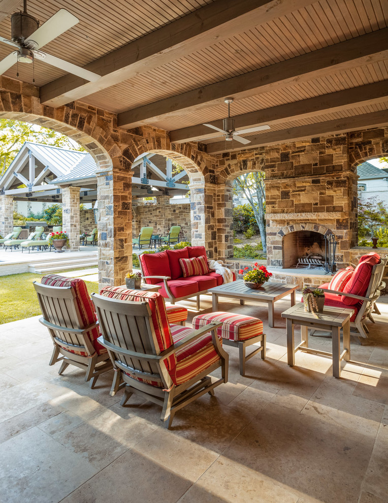 Photo of a mediterranean veranda in Dallas with a fire feature and a roof extension.
