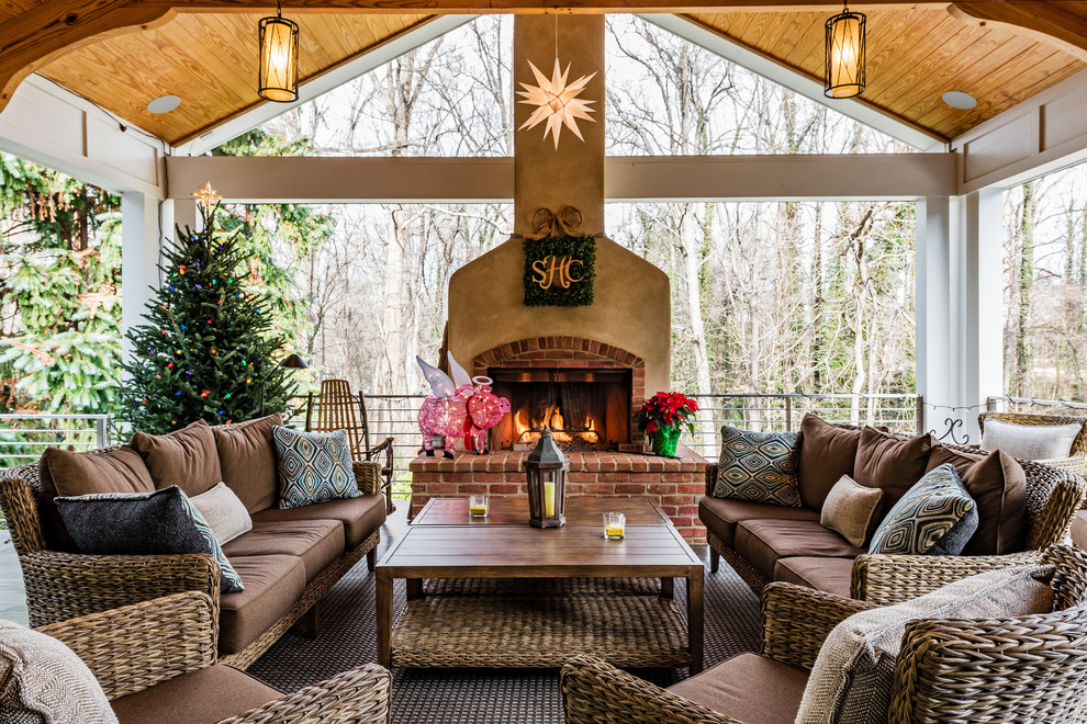 Classic porch idea in Other with a fireplace and a roof extension