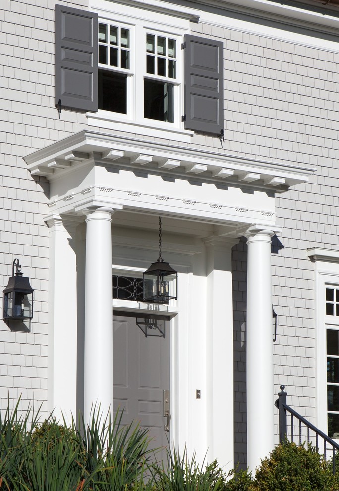This is an example of a mid-sized traditional front porch design in Seattle with an awning.
