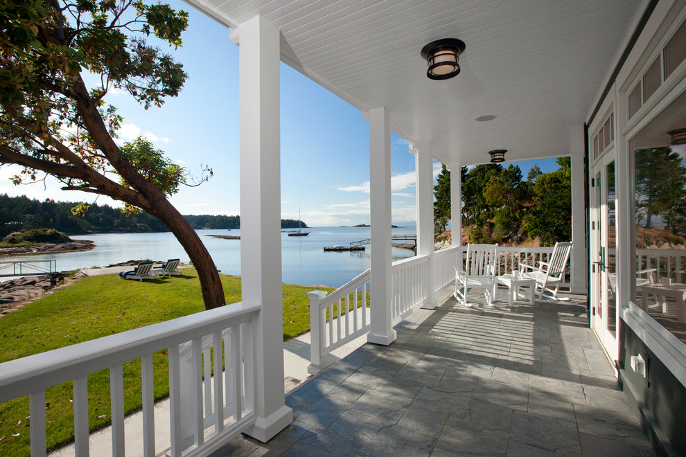 Design ideas for a traditional veranda in Vancouver with a roof extension.