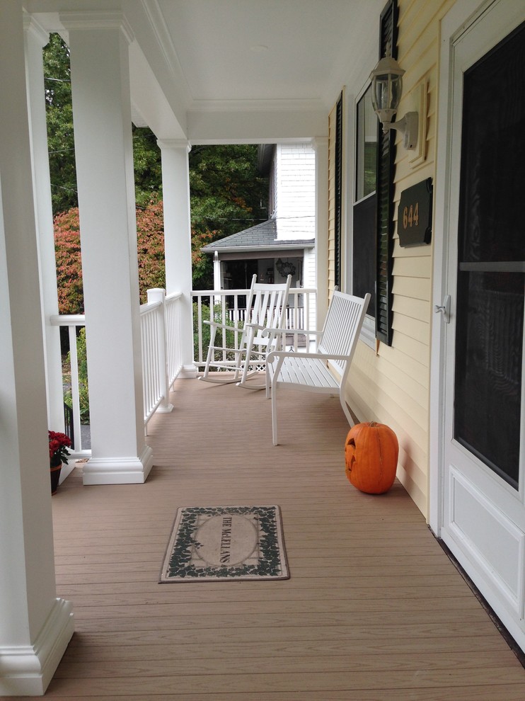 Inspiration for a mid-sized timeless screened-in front porch remodel in St Louis with decking and a roof extension