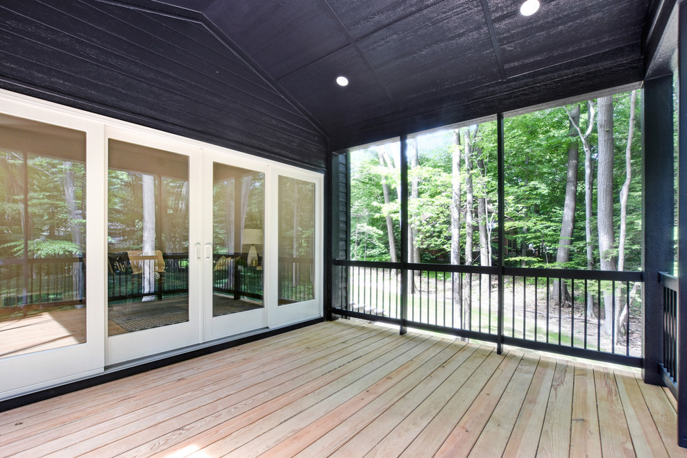 Inspiration for a classic side screened veranda in Grand Rapids with a roof extension.