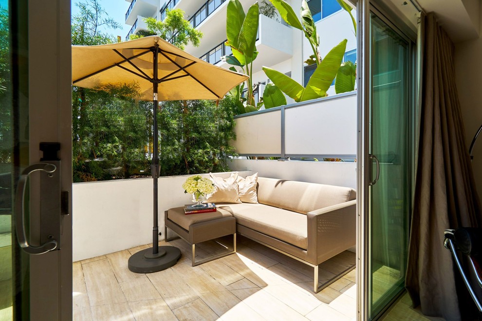 Inspiration for a small contemporary back veranda in Los Angeles with a potted garden and tiled flooring.