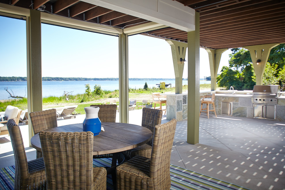 This is an example of a nautical veranda in Grand Rapids with concrete slabs, a roof extension and a bbq area.