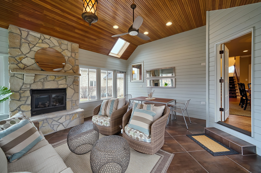 Beach style tile porch photo in Chicago with a fire pit and a roof extension