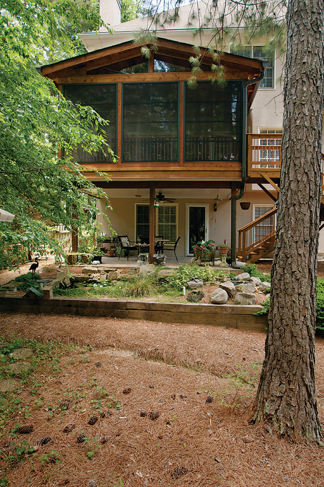 Inspiration for a mid-sized timeless back porch remodel in Atlanta with a roof extension