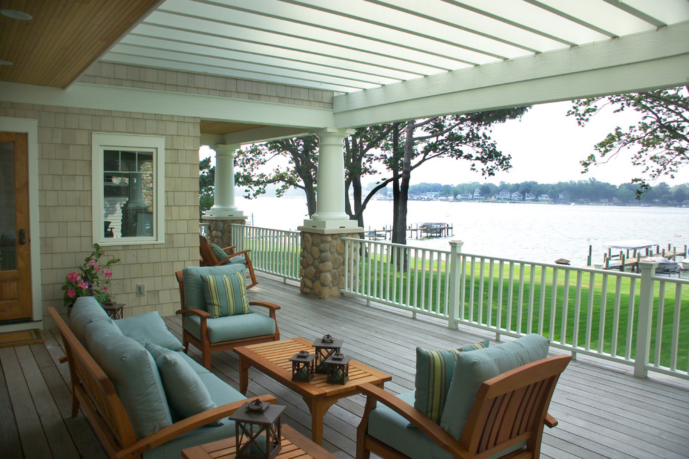 Large transitional back porch idea in Grand Rapids with decking and a pergola
