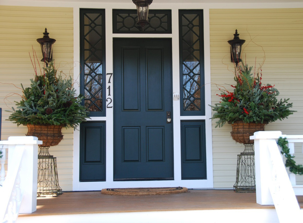 Inspiration for a large traditional front veranda in Chicago with a potted garden, decking and a roof extension.