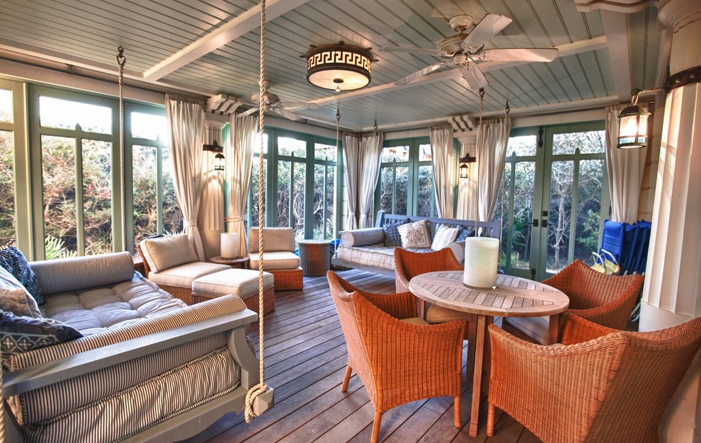 Photo of a beach style veranda in Other with decking, a roof extension and feature lighting.