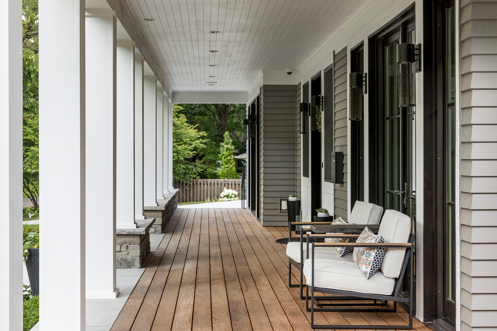 Inspiration for a large classic front veranda in Minneapolis with a roof extension.