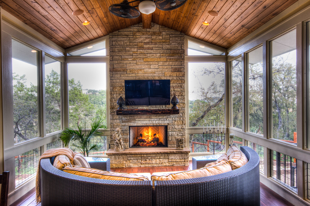 Inspiration for a large eclectic screened-in back porch remodel in Austin with decking