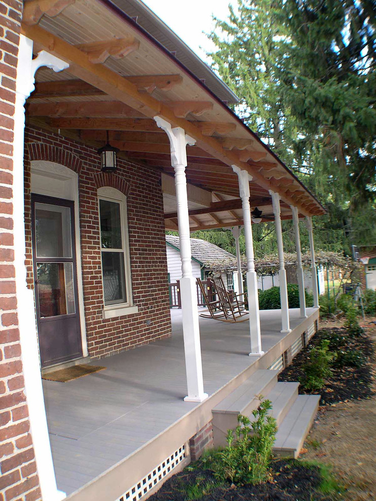 Mid-sized classic front porch idea in Philadelphia with a roof extension
