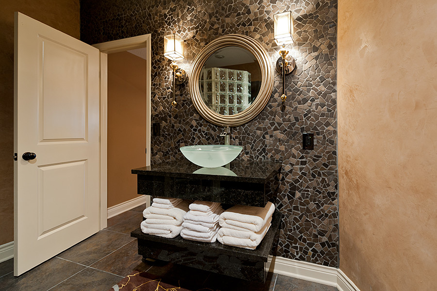 Medium sized contemporary cloakroom in Kansas City with flat-panel cabinets, black cabinets, a two-piece toilet, multi-coloured tiles, mosaic tiles, brown walls, slate flooring, a vessel sink and solid surface worktops.