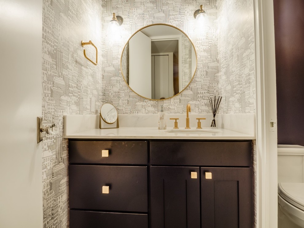 Photo of a small contemporary cloakroom in New York with shaker cabinets, a two-piece toilet, white tiles, ceramic tiles, a submerged sink, marble worktops, dark wood cabinets, white walls and white worktops.