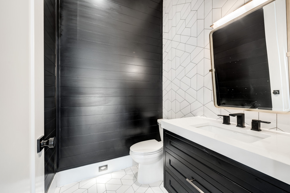 Design ideas for a classic cloakroom in Dallas with recessed-panel cabinets, black cabinets, a one-piece toilet, white tiles, ceramic tiles, black walls, ceramic flooring, a submerged sink, engineered stone worktops, white floors, white worktops, a floating vanity unit and tongue and groove walls.
