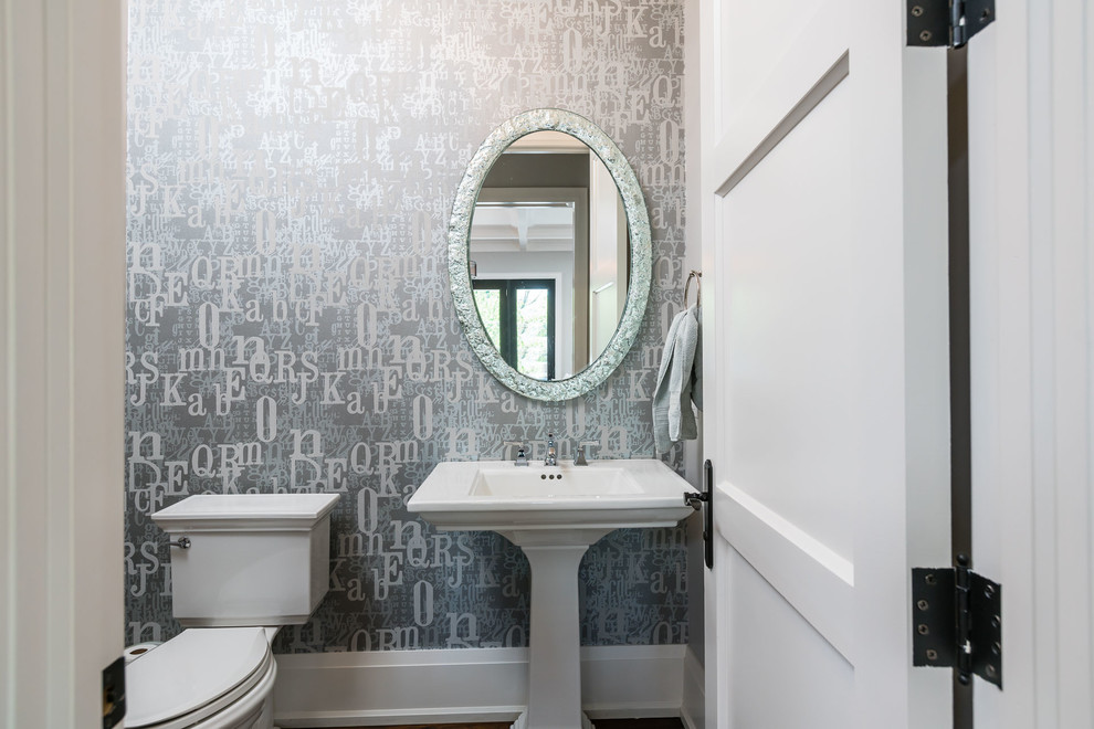 Powder room - mid-sized transitional powder room idea in Toronto with a pedestal sink and gray walls