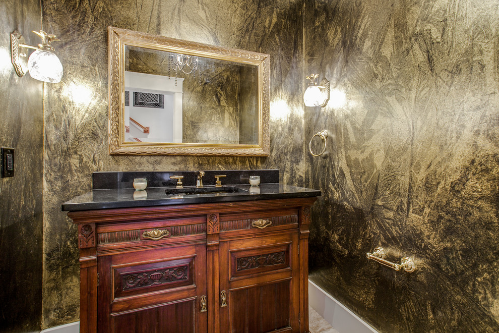 Example of a mid-sized classic beige tile and ceramic tile ceramic tile and beige floor powder room design in Dallas with flat-panel cabinets, a two-piece toilet, an undermount sink, dark wood cabinets, multicolored walls and marble countertops