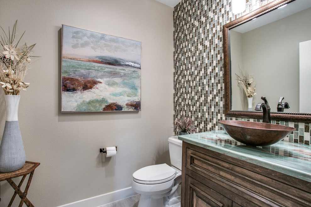 Mid-sized arts and crafts multicolored tile and mosaic tile porcelain tile and gray floor powder room photo in Dallas with furniture-like cabinets, brown cabinets, a two-piece toilet, gray walls, a vessel sink, onyx countertops and turquoise countertops