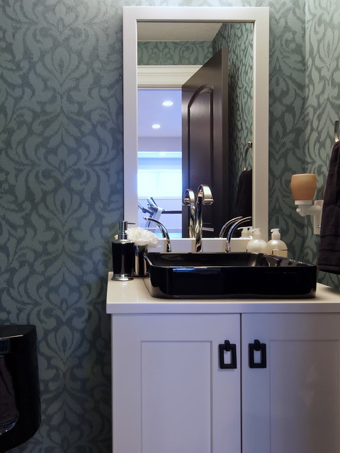 This is an example of a medium sized traditional cloakroom in Calgary with shaker cabinets, white cabinets, a one-piece toilet, green walls and a vessel sink.