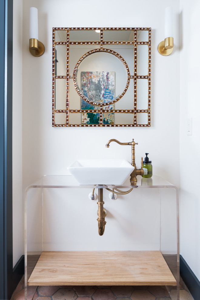 Inspiration for a transitional terra-cotta tile powder room remodel in Birmingham with open cabinets, white walls and a vessel sink