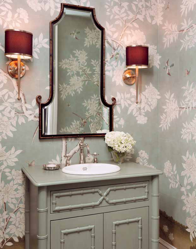 ニューヨークにあるトラディショナルスタイルのおしゃれなトイレ・洗面所 (オーバーカウンターシンク、家具調キャビネット、グレーのキャビネット、マルチカラーの壁、グリーンの洗面カウンター) の写真