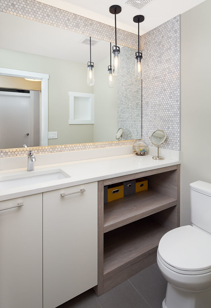 Example of a transitional powder room design in Calgary