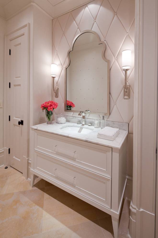 Photo of a small traditional cloakroom in Atlanta with a submerged sink, recessed-panel cabinets, white cabinets, marble worktops, white walls, limestone flooring and beige tiles.