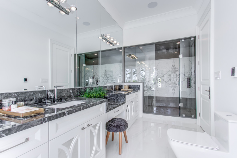Expansive modern cloakroom in Toronto with louvered cabinets, a one-piece toilet, marble flooring, a built-in sink, granite worktops and white floors.