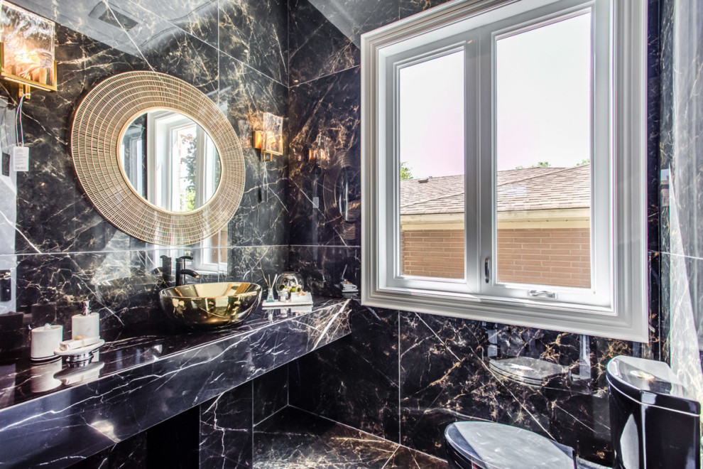 Photo of an expansive modern cloakroom in Toronto with louvered cabinets, black cabinets, a one-piece toilet, black tiles, marble tiles, black walls, marble flooring, a console sink, granite worktops, black floors and black worktops.