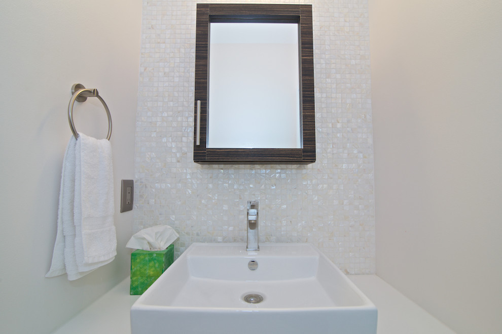 Photo of a medium sized contemporary cloakroom in Jacksonville with flat-panel cabinets, dark wood cabinets, a two-piece toilet, multi-coloured tiles, white tiles, mosaic tiles, white walls, a vessel sink and engineered stone worktops.