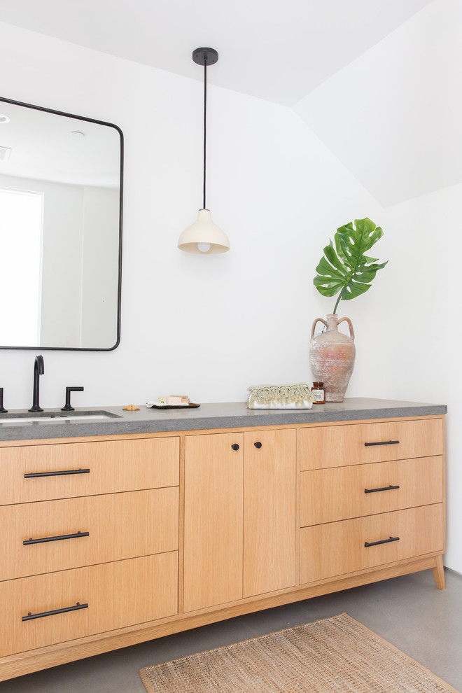 Design ideas for a modern cloakroom in Los Angeles with flat-panel cabinets, light wood cabinets, white walls, concrete flooring, a submerged sink, grey floors and grey worktops.