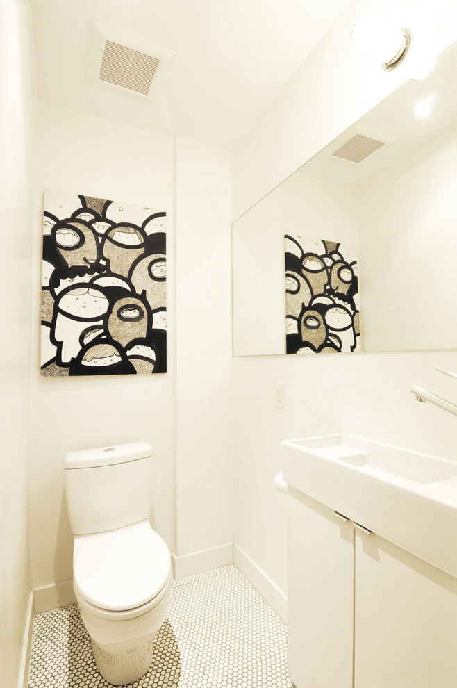 Inspiration for a small modern cloakroom in Toronto with flat-panel cabinets, white cabinets, a two-piece toilet, white tiles, white walls, mosaic tile flooring and a vessel sink.