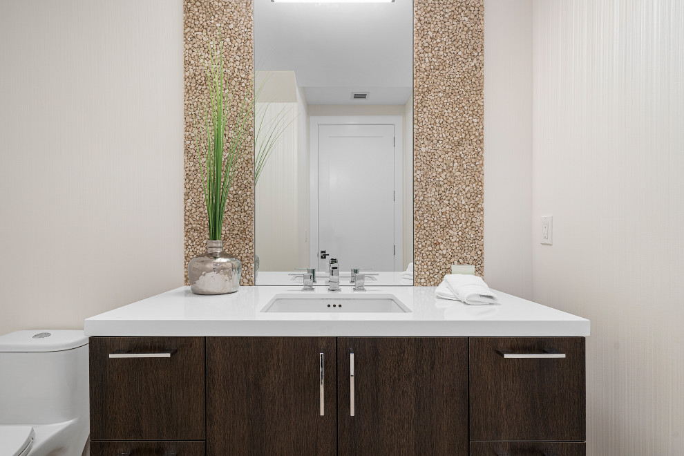 Design ideas for a medium sized contemporary cloakroom in Miami with flat-panel cabinets, brown cabinets, a one-piece toilet, beige walls, cement flooring, engineered stone worktops, beige floors and white worktops.