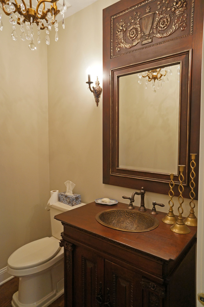 Powder room - mid-sized traditional beige tile and porcelain tile porcelain tile powder room idea in Philadelphia with a drop-in sink, furniture-like cabinets, wood countertops, a two-piece toilet, beige walls, dark wood cabinets and brown countertops