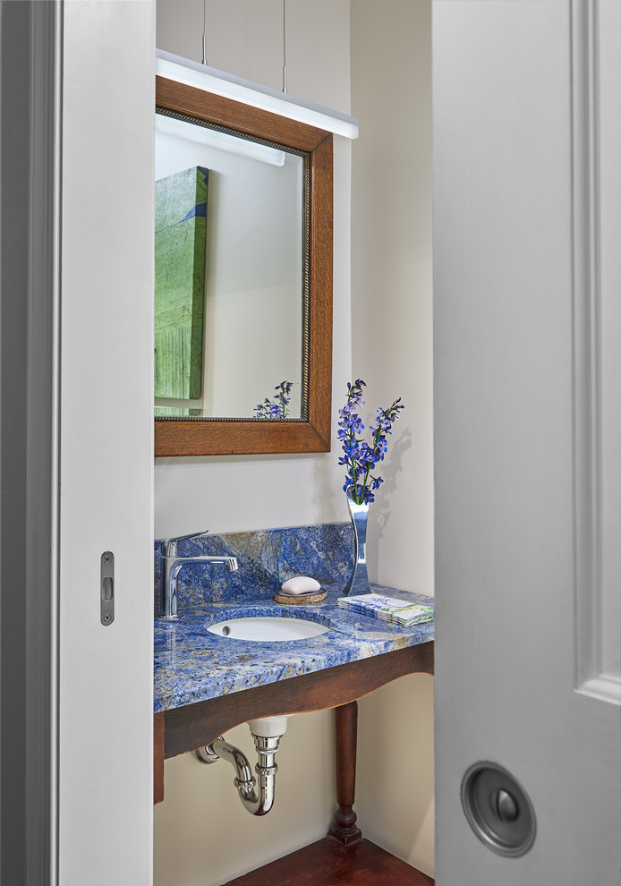 Photo of a medium sized contemporary cloakroom in DC Metro with open cabinets, white walls, dark hardwood flooring, a submerged sink, brown floors and blue worktops.